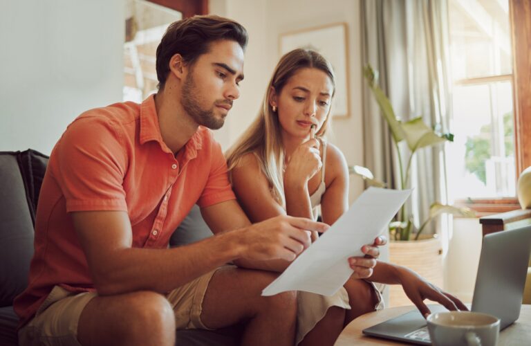 Anxiety, debt and stress with a couple paying bills on a laptop, checking their budget and savings.