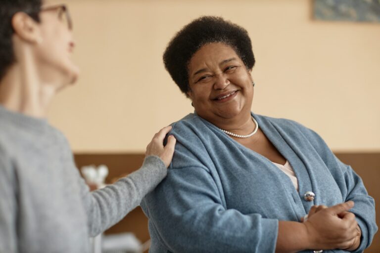 Senior African American Woman Smiling in Group Therapy
